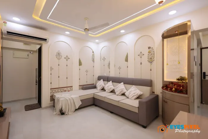 Living room with arched wall panelling and an L-shaped sofa along two walls