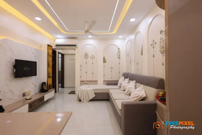 Television unit on a marble panel, seen across an arched-panelled living room