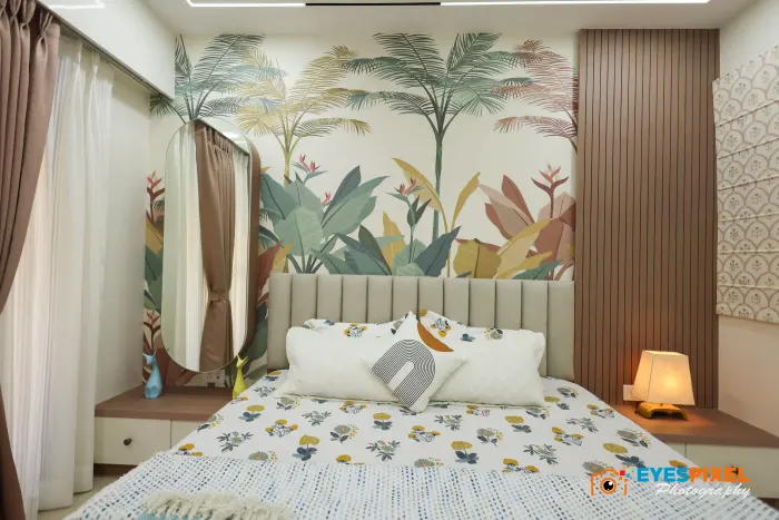 Bedroom with a leaf mural, bedside lamp and fluted wall panelling