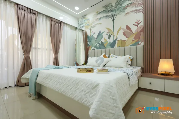 Wide bedroom view with sheer curtains either side of the bed