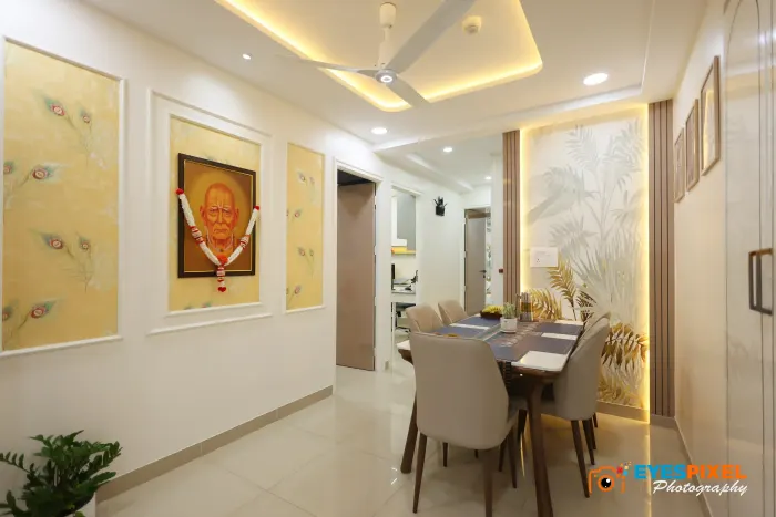 Dining table seen down a passage hung with a framed portrait