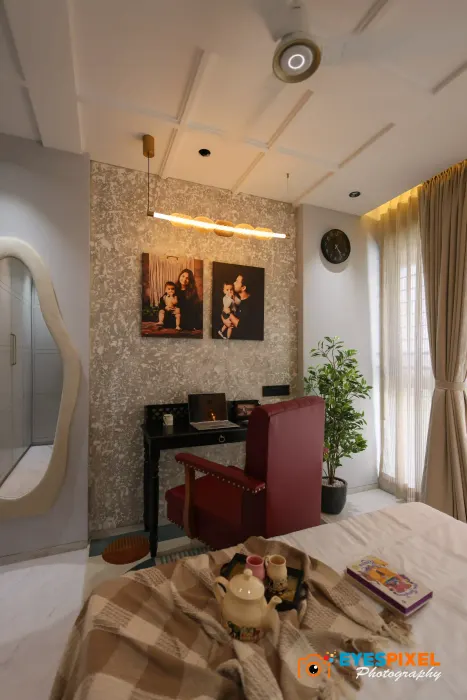 Bedroom dressing corner with a wall mirror, slim console and framed prints above it