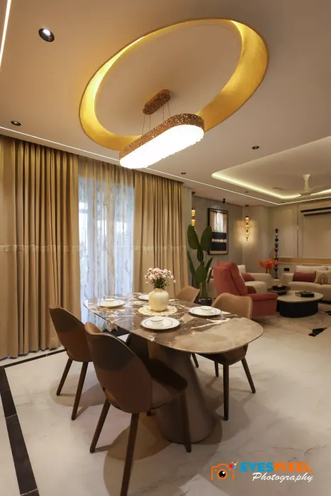 Dining area seen from the living room, with a circular light cove above the table