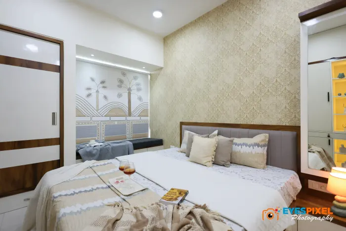Bedroom with a printed feature wall, tall mirror and a made bed