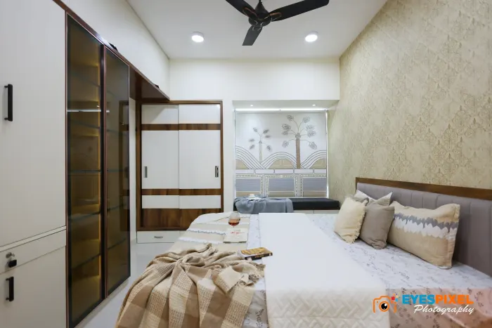 Sliding wardrobe with fluted glass panels alongside a bed