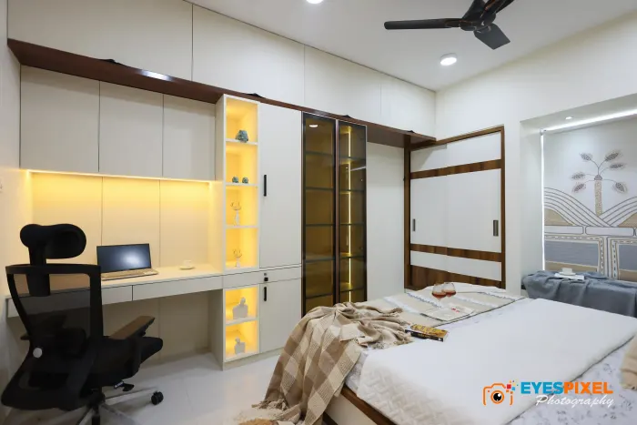 Workstation and lit niches built into a bedroom wall