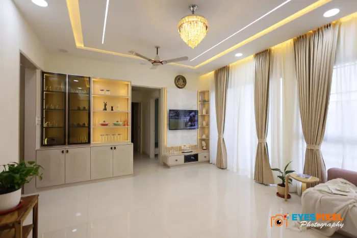 Wide living room with a chandelier, display cabinets and full-height curtains