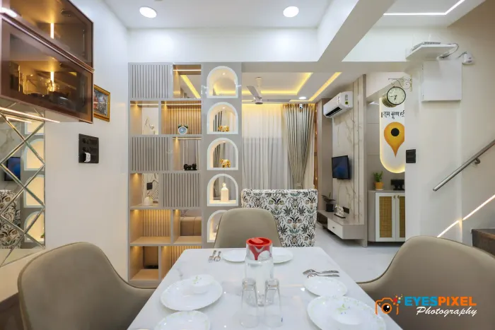 Dining area with a lit display unit and a passage through to the living room