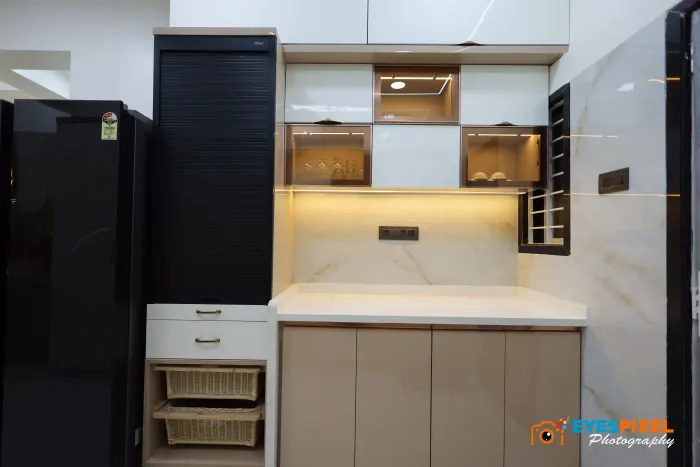 Tall kitchen units flanking a marble counter and open shelf