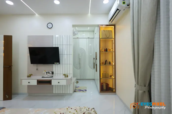 Television unit and lit display column in a white living room