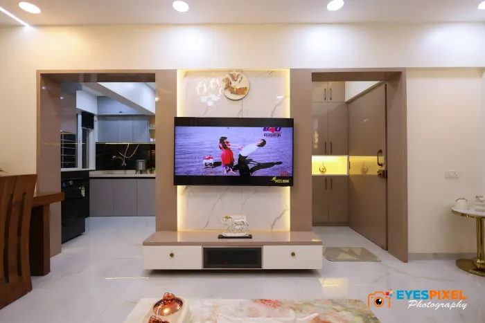 Living room television wall seen from the passage, with the kitchen beyond