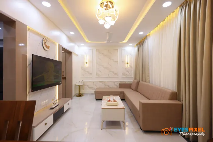 Living room with a marble feature wall, wall lights and a long low sofa