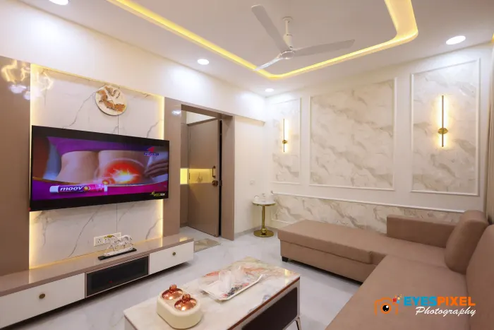 Television unit lit from behind on a marble panelled wall