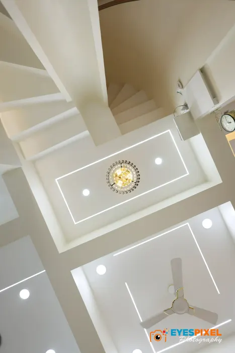 Stairwell looking up to a recessed ceiling and a wall clock