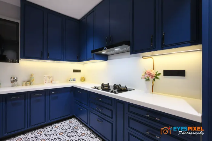Navy blue shaker kitchen with a white counter and patterned floor tiles