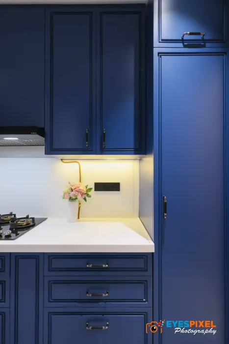 Tall navy kitchen units beside the hob and counter