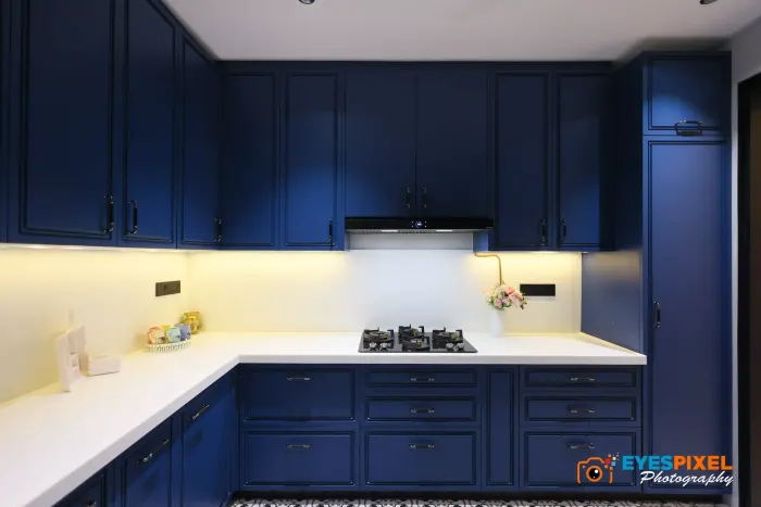 Wide view of a navy kitchen running along two walls