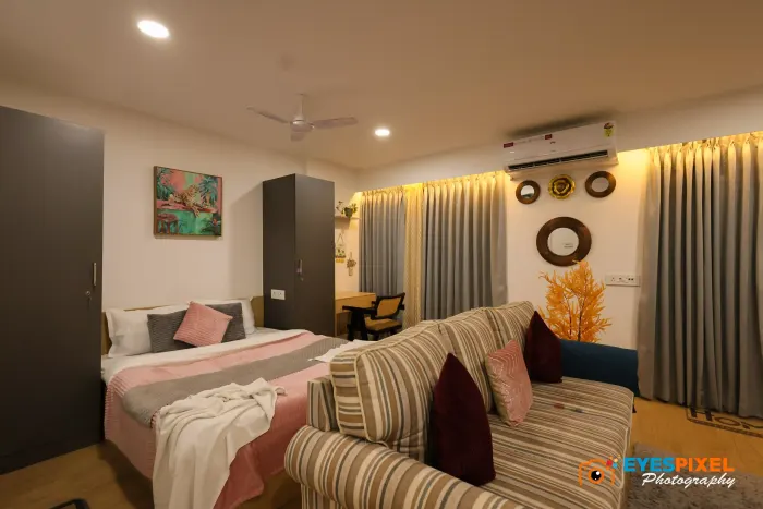 Bed and sofa sharing one room in a compact serviced apartment
