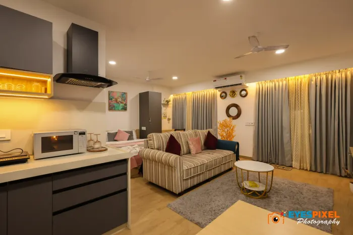 Studio apartment with a kitchen counter in the foreground and a sofa beyond