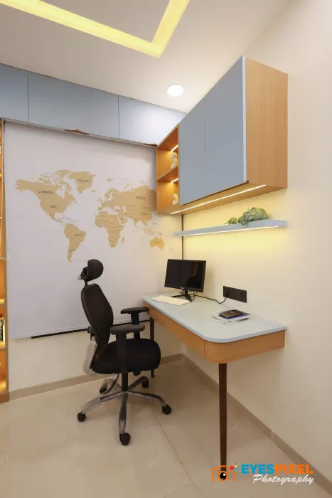 Home office with a wall-mounted desk, task chair and a world map wall