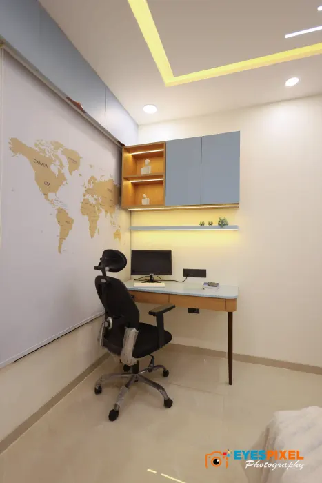 Workstation with overhead cabinets and a lit shelf above the desk