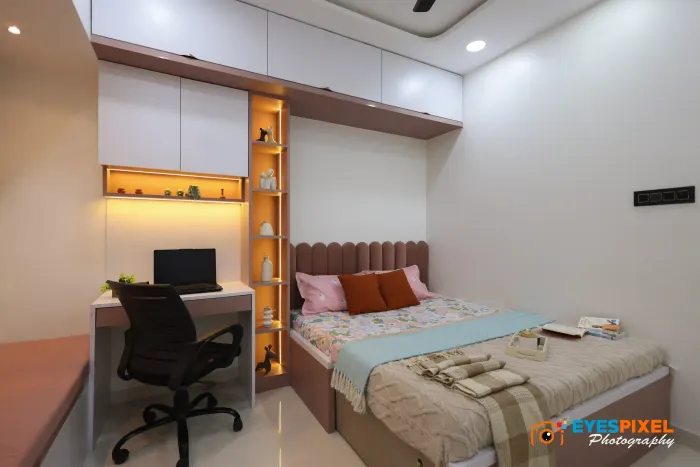 Bedroom desk and upholstered bed sharing one wall of built-in joinery