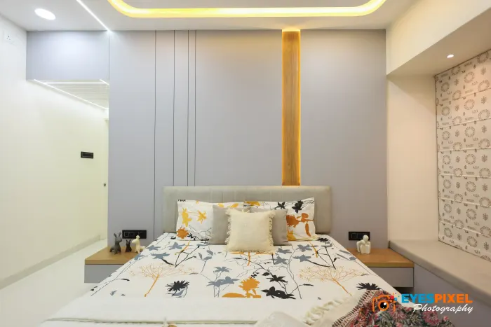 Wide view of a bedroom headboard wall with textured panelling on either side