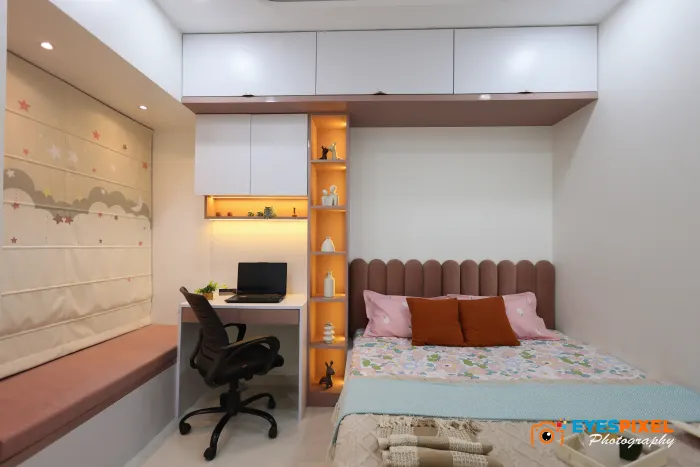 Bedroom with a study desk, task chair and a lit display column beside the bed