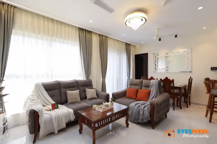 Villa living room with grey sofas, orange cushions and a wooden centre table