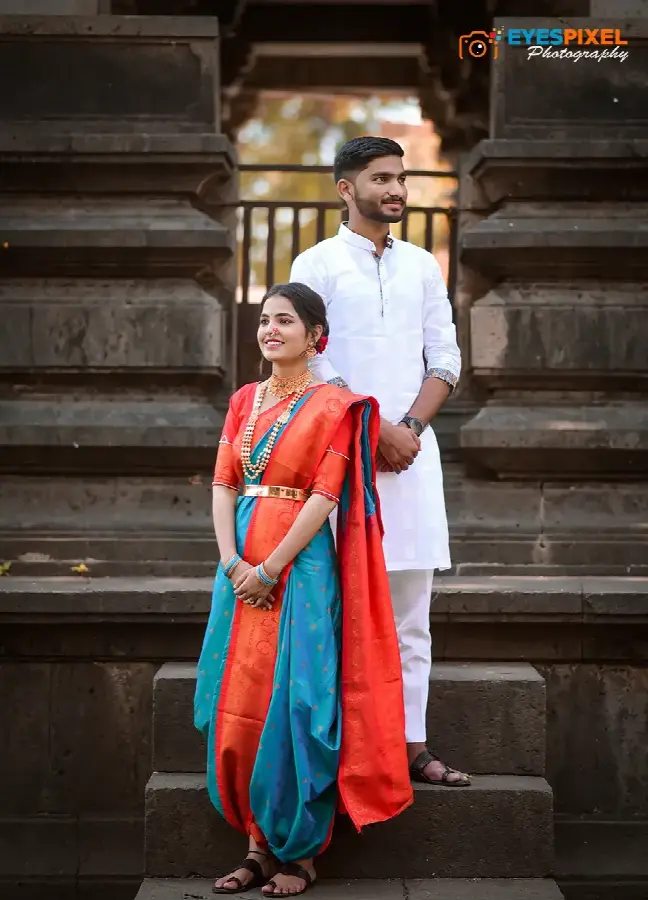 Couple in traditional Maharashtrian dress on the stone steps of an old temple