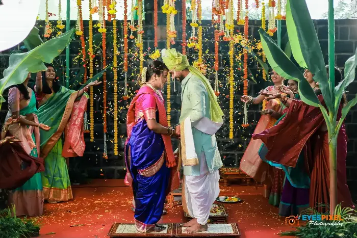 Guests showering the bride and groom with rice and petals during the ceremony